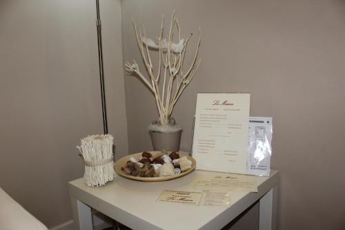 a table with a bowl of cookies and a box on it at La Maison in Vallata