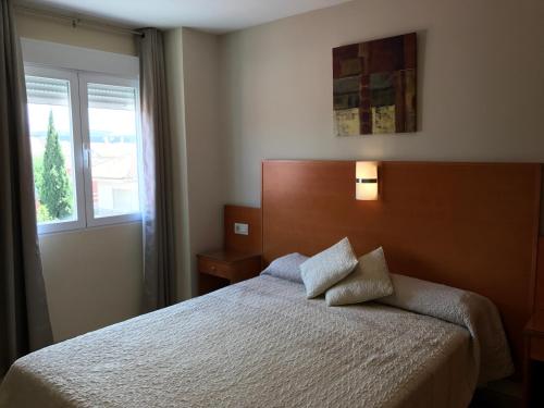 a bedroom with a bed and a window at Los Galanes in Granada