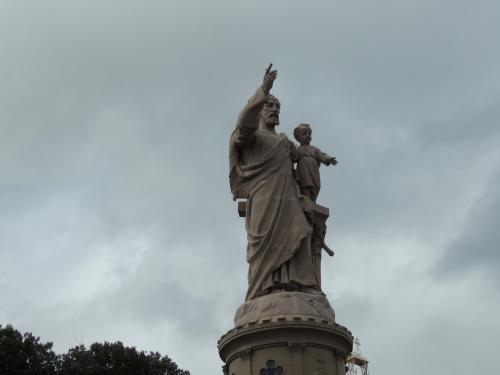 a statue of a woman with her arm in the air at L'Espaviot aux portes du Puy en Velay in Espaly-Saint-Marcel