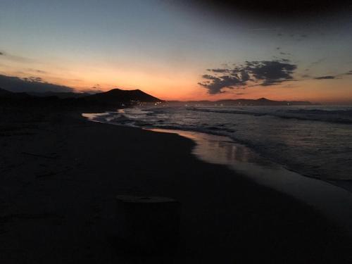 a sunset on a beach with the ocean at Camera vista mare, ingresso indipendente in" Villa VìVì" in Siniscola