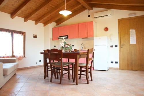 a kitchen with a table and chairs and a refrigerator at Agriturismo Albarello in Sona