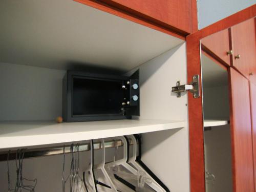 a room with a shelf with a microwave on a wall at Belleza Villa in Lixouri