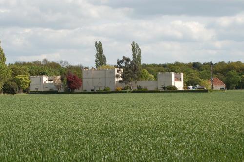 a field of green grass with a building in the background at The East Wing at Rufford Park Lodge, Hot Tub Retreat in Edwinstowe
