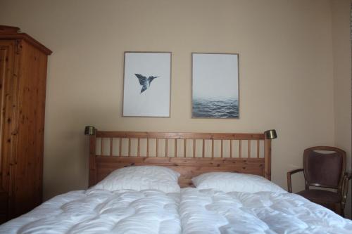 1 dormitorio con 1 cama y un pájaro en la pared en Ferienhaus Lilli en Pruchten