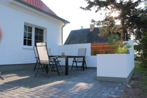 a patio with chairs and a table in front of a house at Ferienhaus Lilli in Pruchten