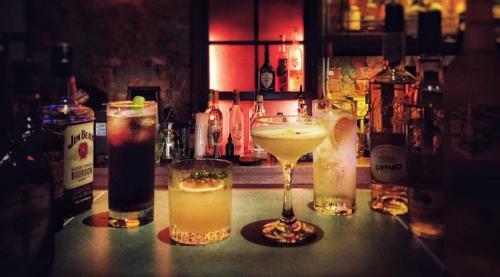 a group of three cocktails sitting on a bar at GOIN Old House & Bar in Tainan