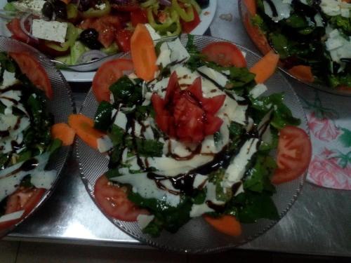 a plate of food with tomatoes and vegetables on it at Хотел Свети Трифон in Melnik