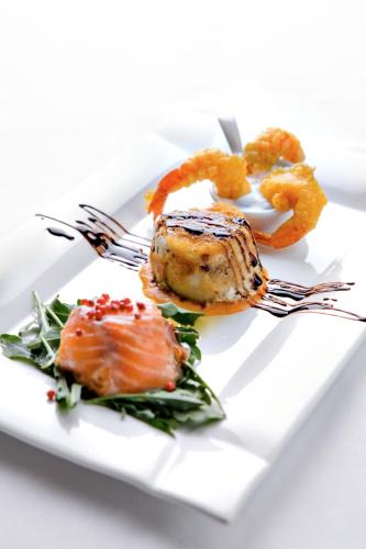 a plate of food with a piece of meat and shrimp at Masseria Panareo in Otranto