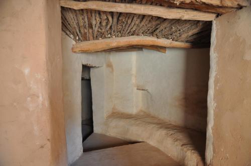 ancient stairway in a building with a wooden ceiling at Kasbah Tigmi N'Oufella in Telouet