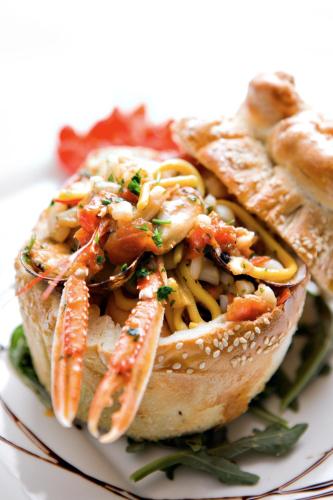 a sandwich with shrimp and pasta on a plate at Masseria Panareo in Otranto