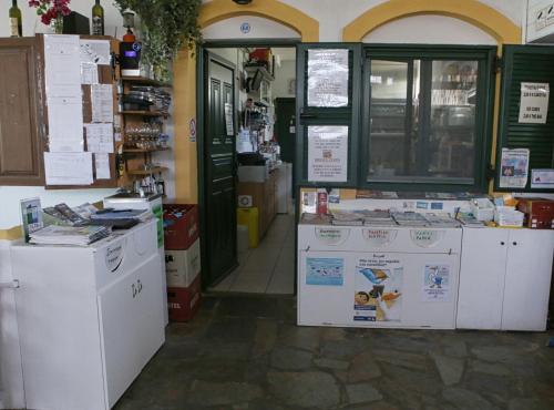 a store with a bunch of machines in a room at Evon's Rooms in Fanari