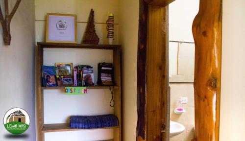 a bathroom with a book shelf and a sink at Casa Hotel Loma Wasi en Cotacachi in Cotacachi