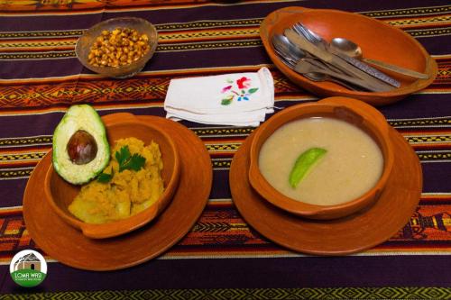 two bowls of soup and a bowl of food on a table at Casa Hotel Loma Wasi en Cotacachi in Cotacachi