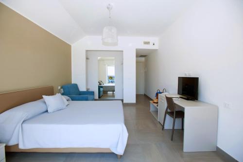 a bedroom with a bed and a desk and a television at B&B Ligure Rooms in Pietra Ligure
