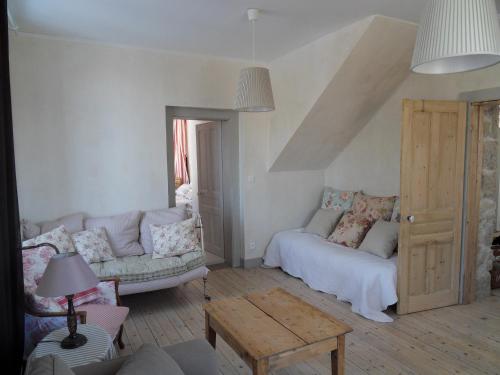 a living room with a couch and a table at La maison de Lilou in Malbuisson