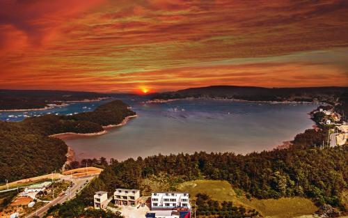 a painting of a sunset over a body of water at Yeosu Blooming Pension in Yeosu