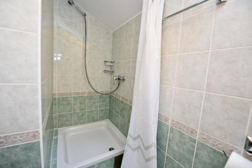 a bathroom with a shower and a toilet at Milka Appartements in Stara Novalja