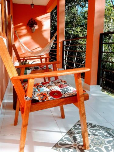 a porch with two chairs and a hammock at Pousada Ouro do Vintem in Conceição do Mato Dentro