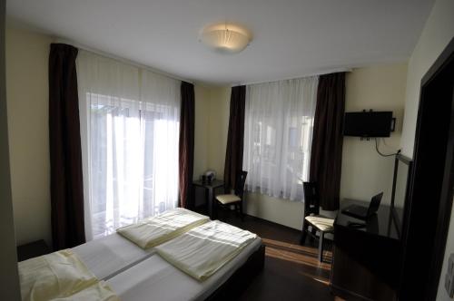 a bedroom with a bed and a desk and window at Marcello Mielno in Mielno