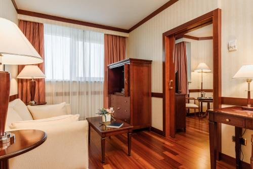 A bed or beds in a room at Eurostars Gran Hotel Santiago