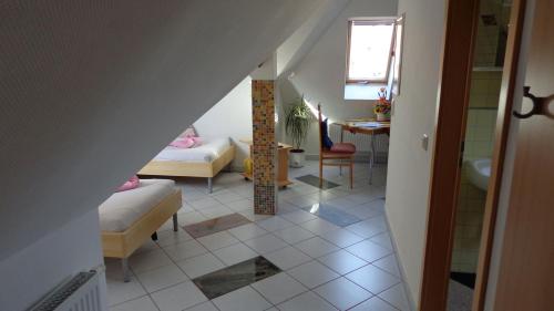 a room with two beds and a living room with a table at Ferienwohnungen Rehn in Dresden