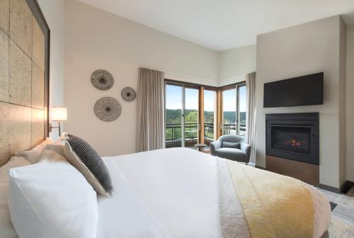 a bedroom with a large bed and a fireplace at Friday Harbor House in Friday Harbor