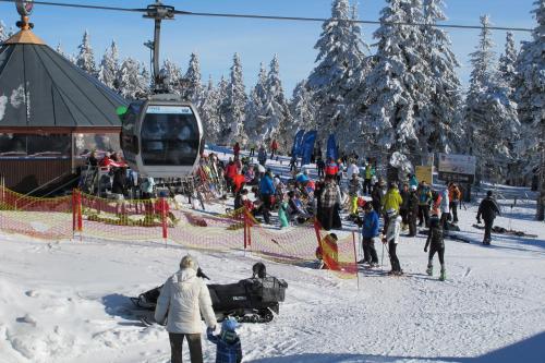a group of people on a ski slope with a ski lift at Horský dům Veronika in Cerny Dul