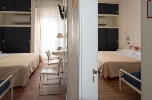 Postel nebo postele na pokoji v ubytování Hotel Nettuno