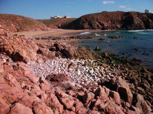 a group of people on a rocky beach at Aftas Beach Studio in Mirleft