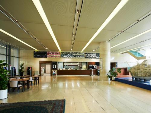 a lobby with tables and chairs in a building at Osaka Academia in Osaka