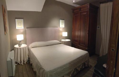 a bedroom with a bed with two lamps on it at B&B Santapau Charme Living in Licodia Eubea