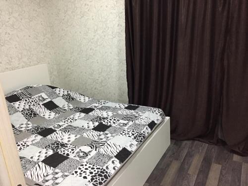 シャフティにあるApartment on ulitsa Mayakovskogo 94のベッドルーム1室(ベッド1台、白黒の掛け布団付)