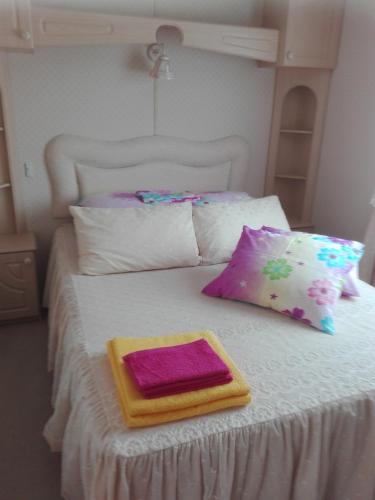 a white bed with two pillows and a tray on it at Treimani Rannamaja in Treimani