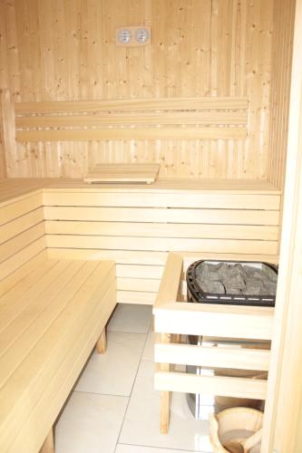 a sauna with wooden walls and a wooden bench at Hotel Modrzewiówka in Lanckorona