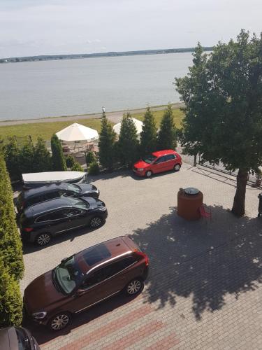 due auto parcheggiate in un parcheggio vicino all'acqua di Villa Stella SPA a Mielno