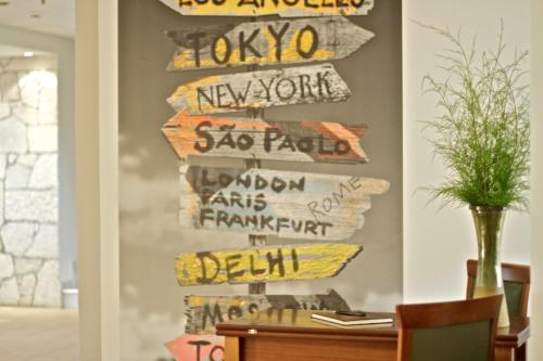 a group of signs hanging on a wall at Solimar Ruby in Malia