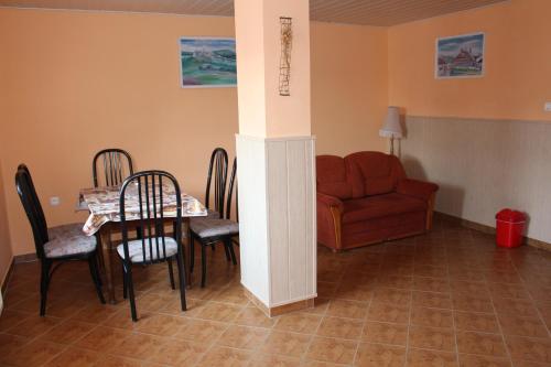 a living room with a table and chairs and a couch at Penzion Chalupka in Spišské Podhradie