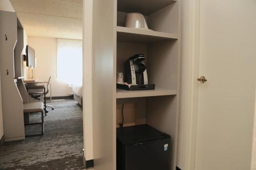 a room with a door open to a room with a desk at Holiday Inn Salem by IHG in Salem