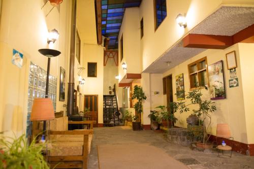 a hallway of a building with potted plants at Los Aticos B&B with Coworking in Cusco