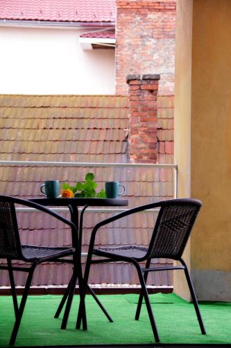 a table with two chairs and a bowl of fruit on it at Freedom in Uzhhorod