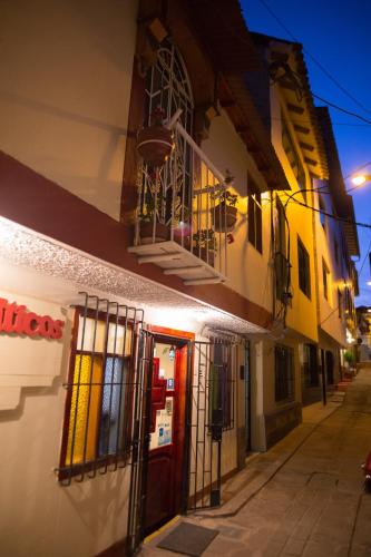 a building with a red door on a street at Los Aticos B&B with Coworking in Cusco