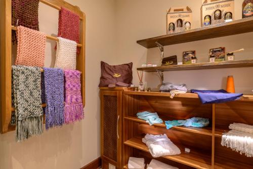 a walk in closet with wooden shelves and towels at Hotel Le Renard - Campos do Jordao in Campos do Jordão