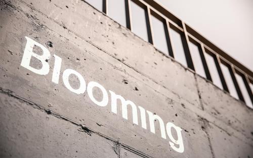 a sign on the side of a building at Yeosu Blooming Pension in Yeosu