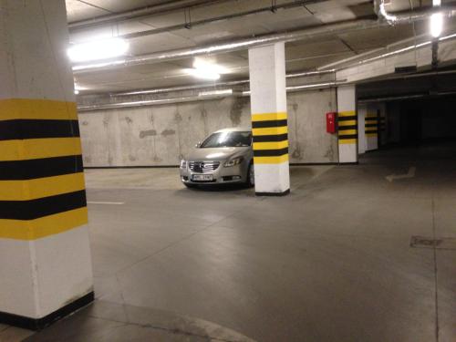 a car parked inside of a parking garage at NEPTUN 46 - 2 sypialnie in Olsztyn