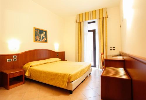 a hotel room with a bed and a window at Garda Family House in Brenzone sul Garda