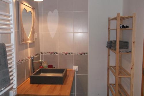 a bathroom with a sink and a mirror at La Grange d'Antan in Cruzy