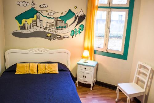 a bedroom with a bed with a city on the wall at Hostal Forestal in Santiago
