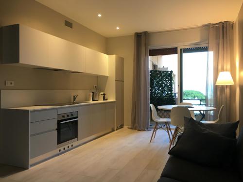 a kitchen with a stove top oven next to a table at Sanremo Luxury Apartament in Sanremo