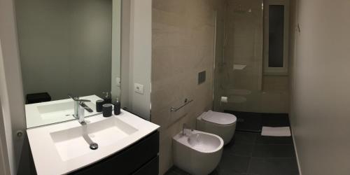 a bathroom with a sink and a toilet at Sanremo Luxury Apartament in Sanremo