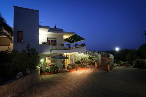 a large house with a patio at night at Casa Mastronardi in Castellana Grotte